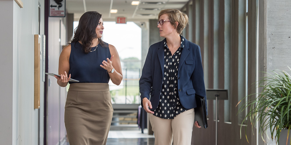 Two women talking on K-State Olathe campus.